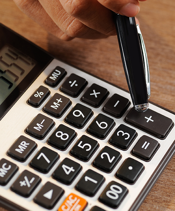 Closeup of accountant counting on calculator